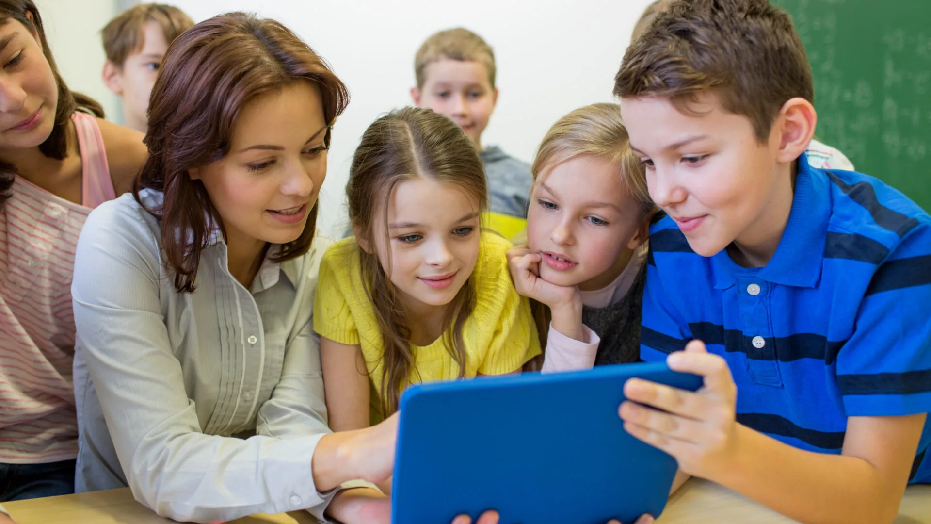 education elementary school learning technology people concept group school kids with teacher looking tablet pc computer classroom